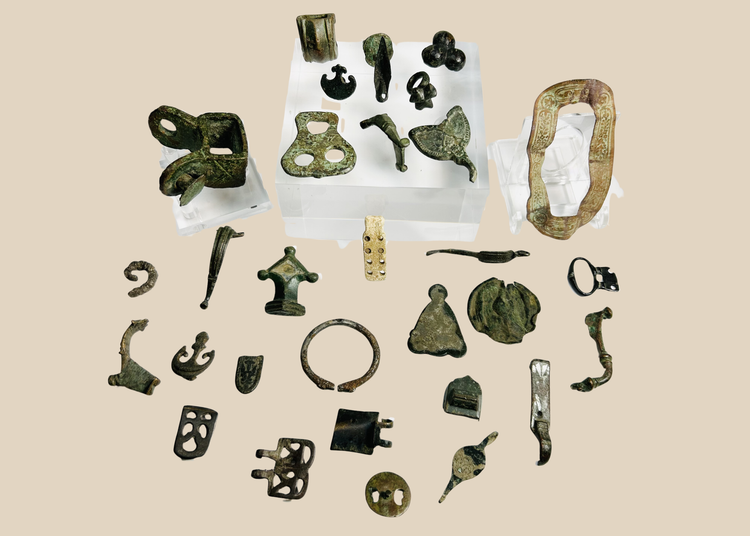 Collection of 31 ancient Roman bronze artifacts including belt mounts, harness fittings, buckles, spearhead fragment, and decorative mounts dating to the Roman Empire (1st–4th century CE
