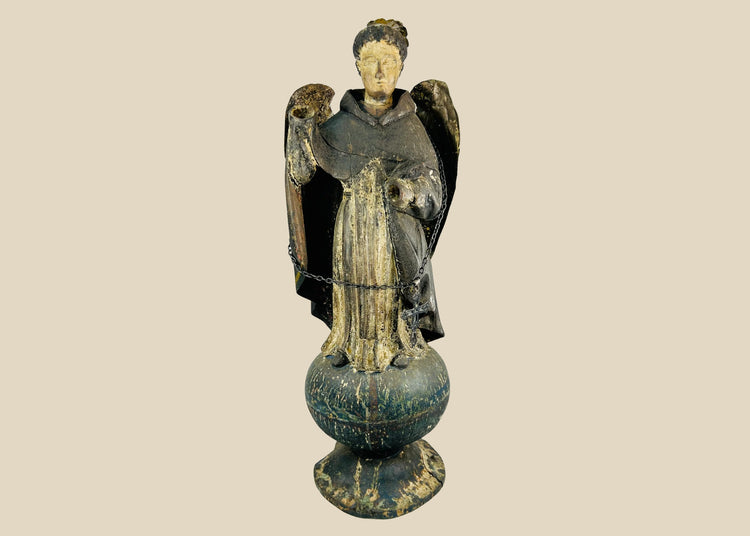 Antique Colonial Latin American polychrome wooden angel or saint figure, 18th–19th century, standing on orb base, gilded wings, remnants of original painted surface, later added sterling silver chain and cross marked 'Sterling, Mexico', traditional folk-religious craftsmanship