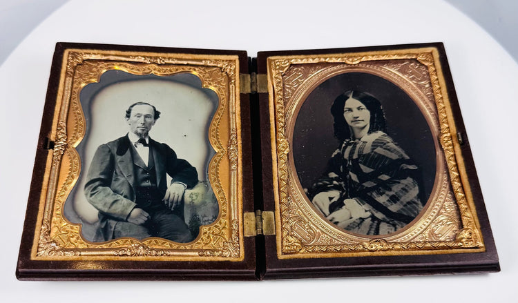 Antique Victorian ambrotype portrait pair with gilt brass mats and velvet lining
