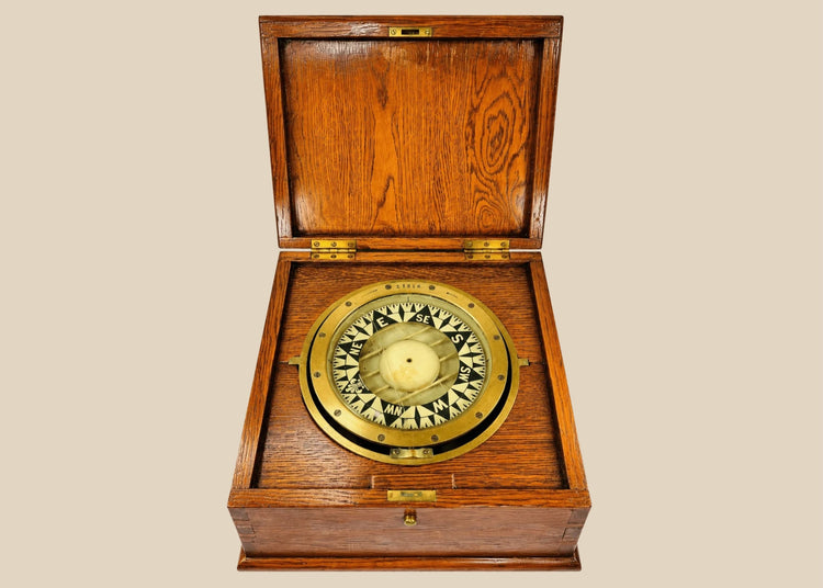 Antique brass ship compass by E.S. Ritchie, mounted in a fitted wooden case, originating from a Canadian political estate; nautical navigation instrument with original glass face, engraved directional markers, and aged patina, representing 19th–20th century maritime craftsmanship and provenance-linked historical significance.