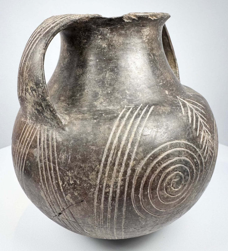 Early Etruscan impasto terracotta amphora with incised spiral and parallel line decorations
