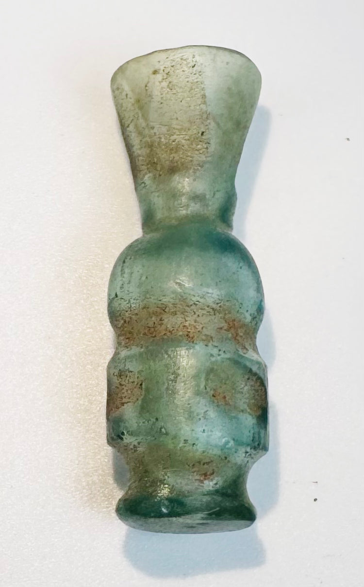 Pale blue-green Islamic glass vessel with iridescence and archaeological weathering