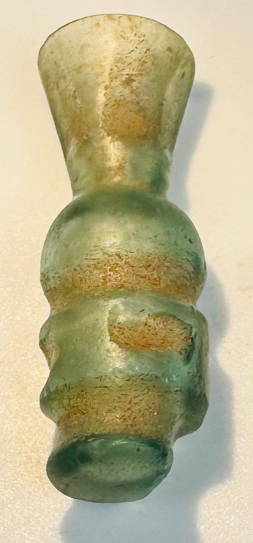 Tiny medieval glass bottle with flared rim, moulded body, and discoid foot