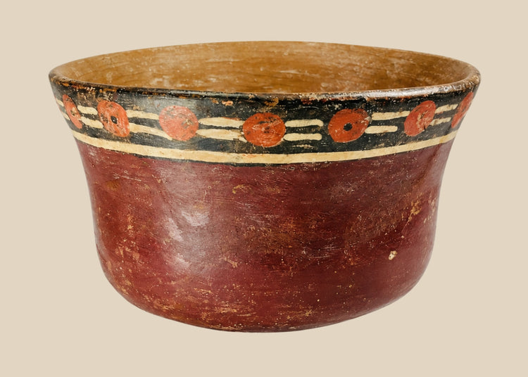 Early Nazca terracotta bowl, circa 100–300 AD, with flared rim and vibrant polychrome decoration of red circular and black-cream geometric motifs, reflecting pre-Columbian ceremonial artistry.