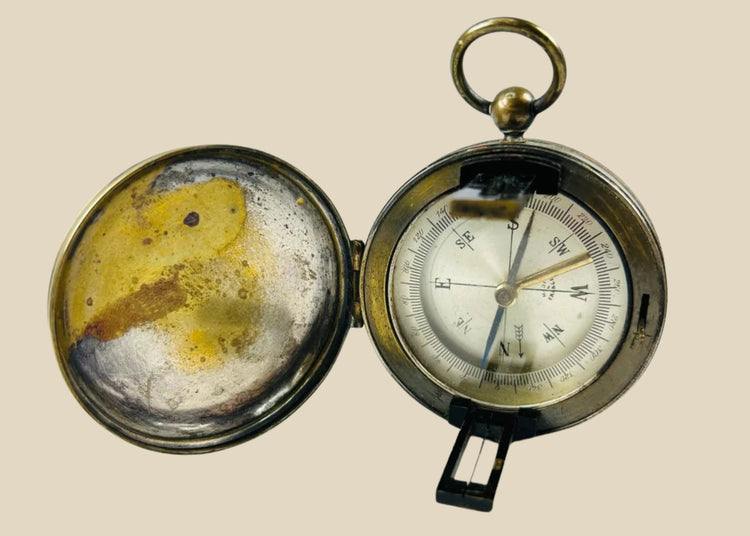 Antique French brass pocket compass with hinged lid, glass-covered dial, and sighting lens, marked “Made in France,” circa 1900–1930.