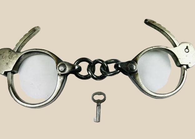 Early 20th-century U.S. handcuffs with key, based on Tower Detective design