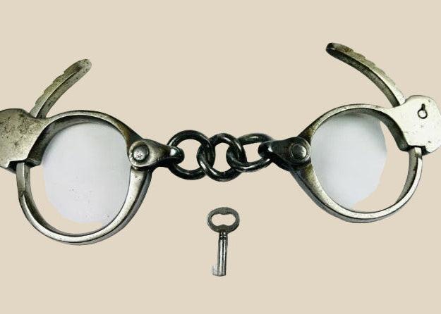 Early 20th-century U.S. handcuffs with key, based on Tower Detective design