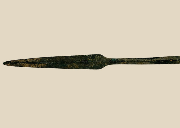 Ancient Cypriot bronze spearhead from the Early Bronze Age, Early Cypriot III period (c. 2500–1900 BCE). Leaf-shaped blade with raised central ridge, straight tang, and four-sided midsection for strength. Functional and ceremonial weapon reflecting Bronze Age metallurgy, hunting, and martial traditions in Eastern Mediterranean societies.