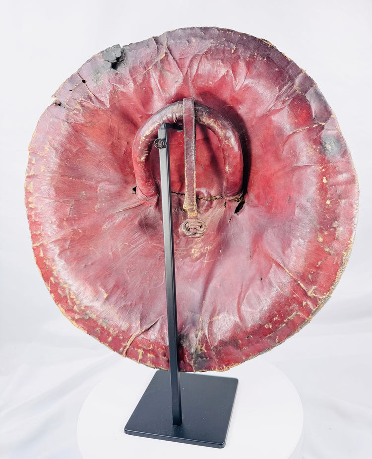 Rear view of an Ethiopian hide shield covered in red leather with original handgrip