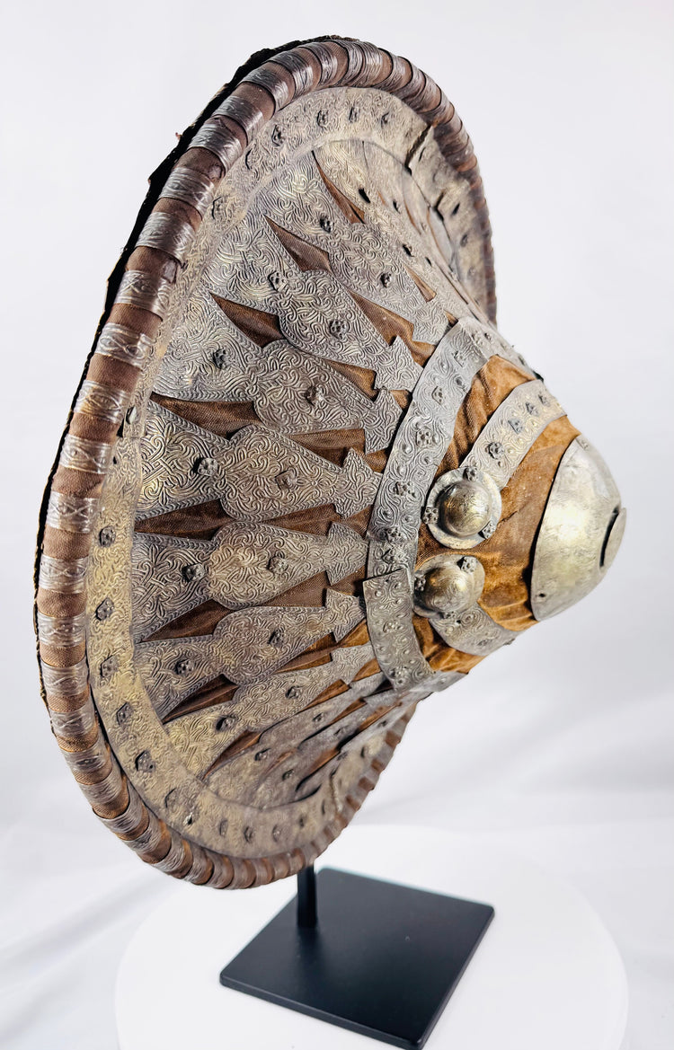 Angled view of a convex Ethiopian Ras shield showing layered metal decoration