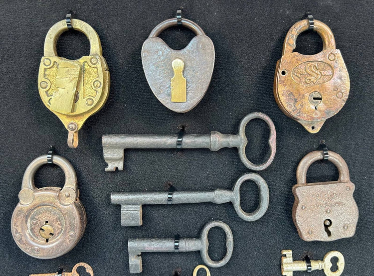 19th century antique lock collection featuring skeleton keys and decorative padlocks