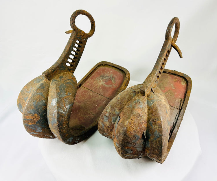 Matched pair of Edo-period Japanese samurai abumi stirrups crafted from hand-forged iron with original red lacquer interiors and aged patina.