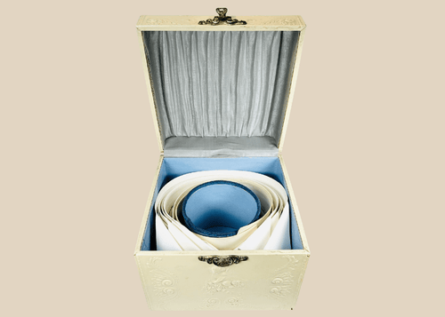 Edwardian collar box with embossed floral design and detachable linen collars