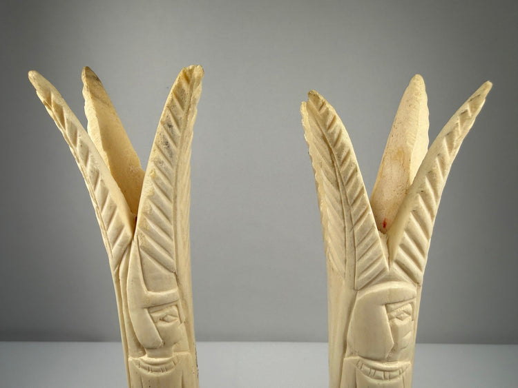 Carved bone lotus and papyrus candlesticks reflecting ancient Egyptian decorative traditions