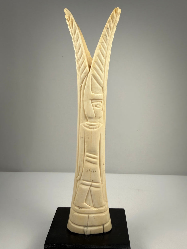 Hand-carved bone candlestick holders with detailed lotus and papyrus forms and aged patina