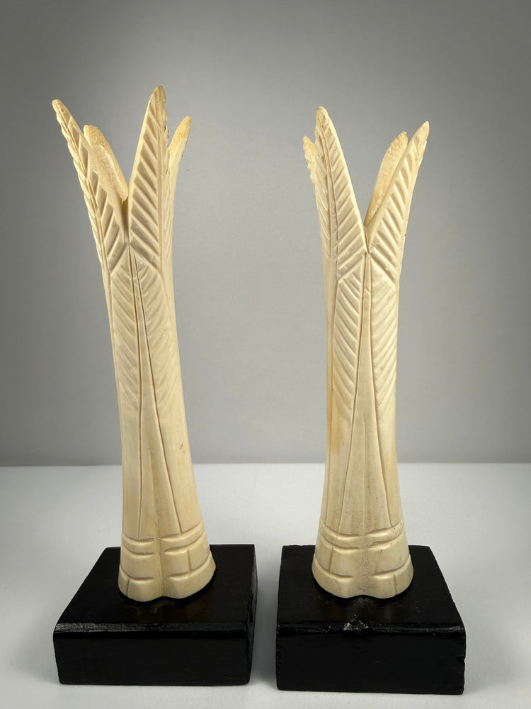 Pair of antique Egyptian-inspired bone candlestick holders mounted on modern black bases
