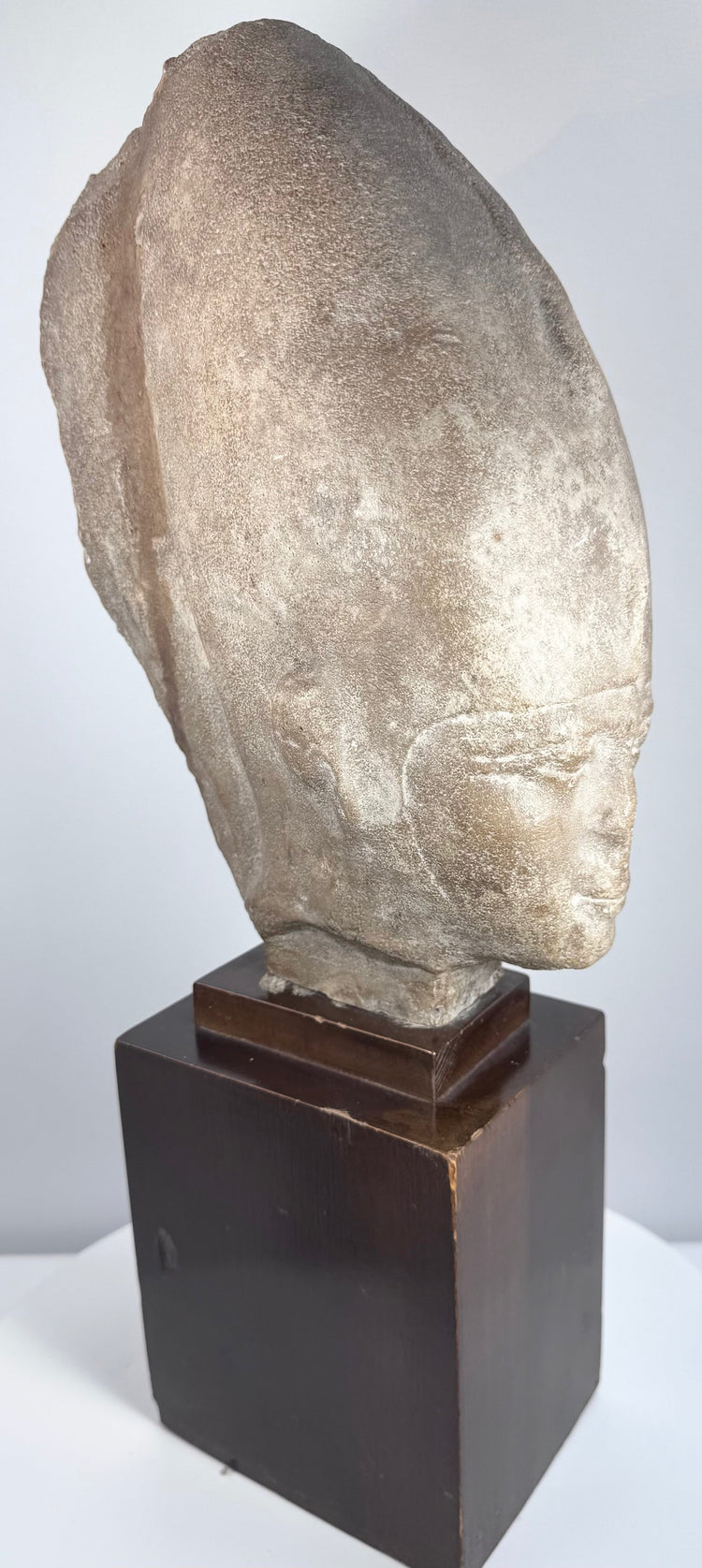 Egyptian-style royal head with almond-shaped eyes, prominent ears, and gently smiling lips