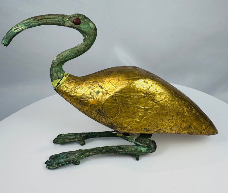Mid-20th century Egyptian Revival ibis sculpture featuring a gold-colored body and green patinated metal elements.
