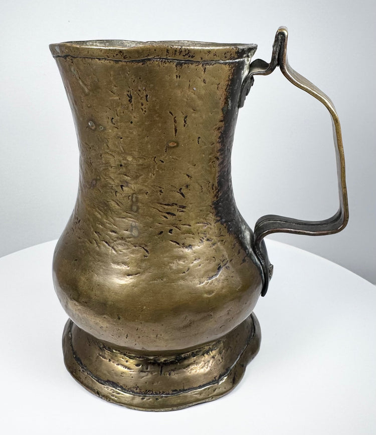 18th-century English George II brass baluster tankard, circa 1727–1760, with aged golden patina and single handle.
