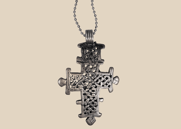 Vintage Ethiopian Coptic cross pendant with intricate openwork lattice design in silver-tone metal.