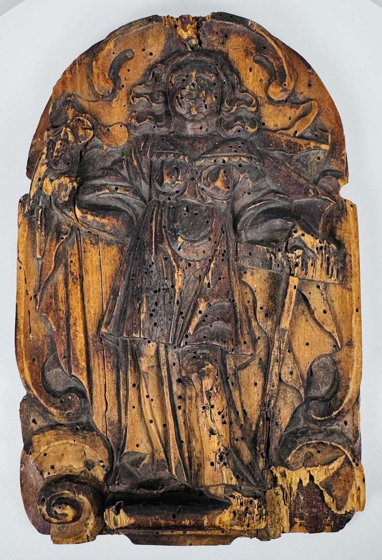 Reverse of an antique wooden religious relief showing the later backing panel and metal hanging bracket