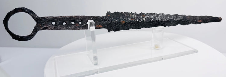 Detailed view of medieval quillon dagger with ring pommel, aged iron surface and tapered fighting blade
