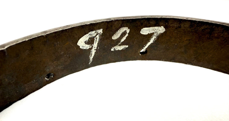 European 17th-century military armor fragment displaying thick steel edges, aged metal texture, and historic forging marks.