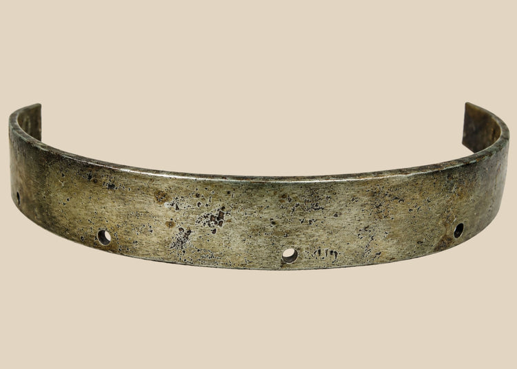 17th-century European siege armour forged steel band, curved protective element with rivet holes and aged patina from historic use.