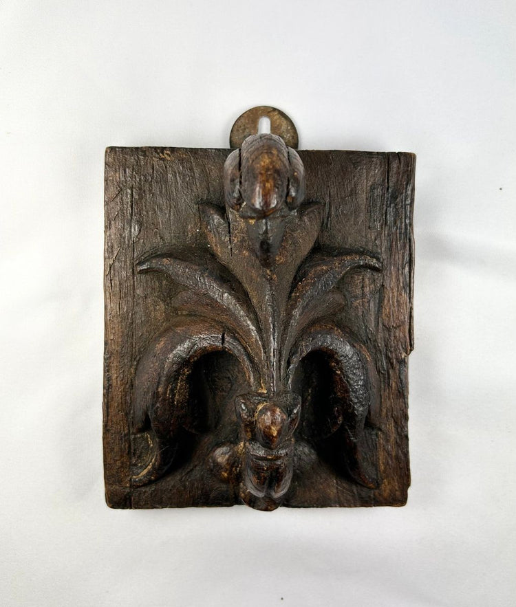 Small 16th-century European carved wooden devotional panel depicting the Pelican in Her Piety with zoomorphic scrollwork and traces of polychrome paint, Renaissance period.