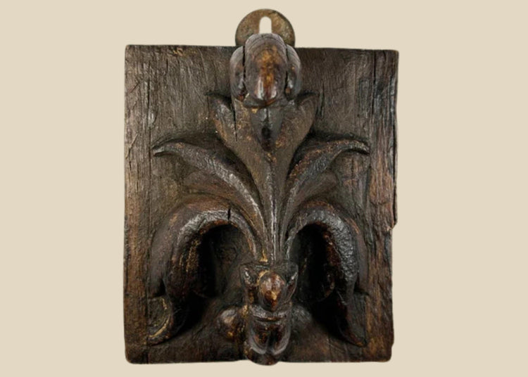 Small 16th-century European carved wooden devotional panel depicting the Pelican in Her Piety with zoomorphic scrollwork and traces of polychrome paint, Renaissance period.
