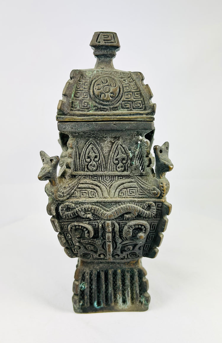 Square Chinese fang yi bronze vessel with roofed lid, cast taotie masks, leiwen ground, curled kui dragons, and zoomorphic shoulder protomes, dark patina with green/blue encrustation, late Qing to early Republic period, ca. 1880–1930.