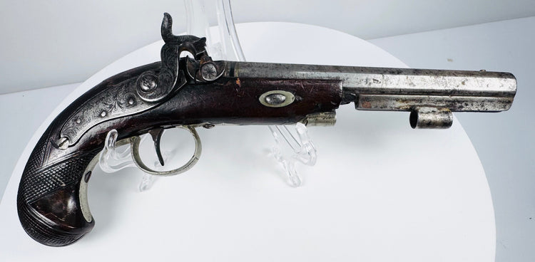Close-up of octagonal barrel and engraved metalwork on 19th-century English percussion pistol