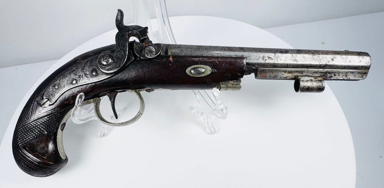 Close-up of octagonal barrel and engraved metalwork on 19th-century English percussion pistol