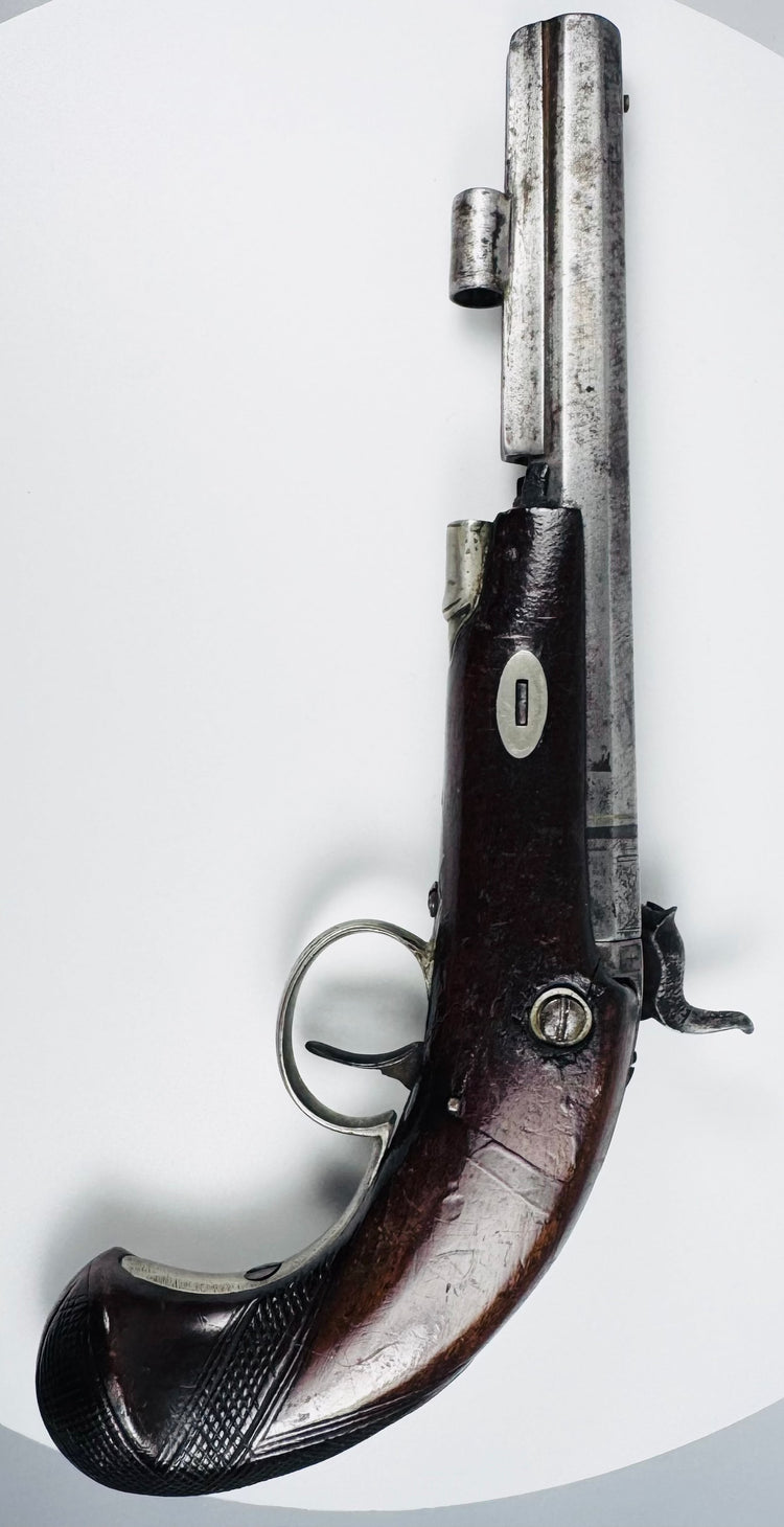 Top view of antique Fenton percussion pistol showing octagonal barrel and engraved steel fittings