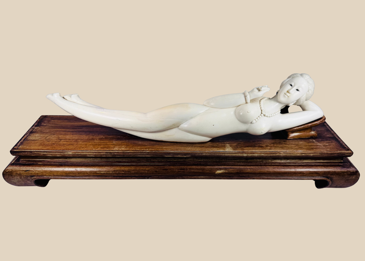 Monumental Chinese doctor’s lady-style reclining sculpture with carved jewellery, pointed footwear and fitted hardwood pedestal