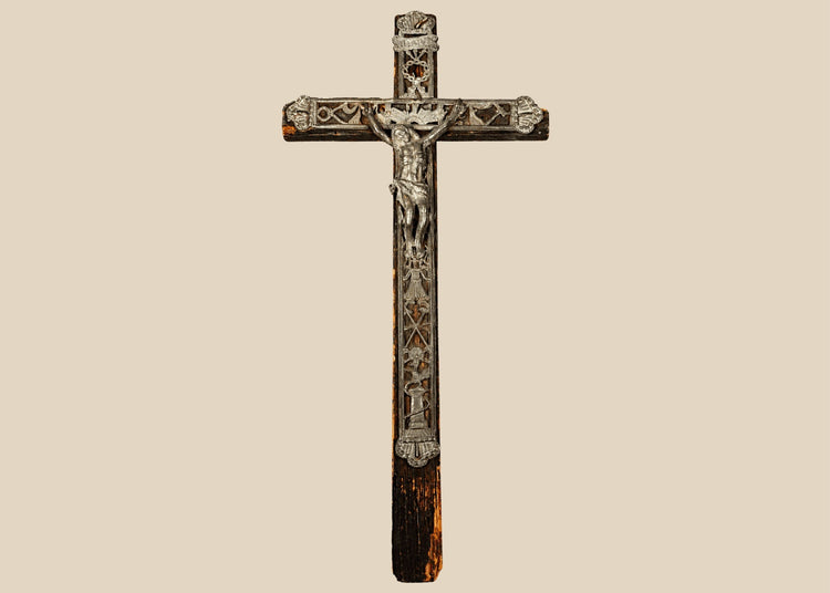 18th-century French peddler’s crucifix with embossed lead religious figures mounted on a dark-painted pine wooden cross.