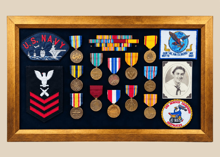 Framed U.S. Navy veteran shadow box featuring medals, patches, ribbon bars, and portrait photograph