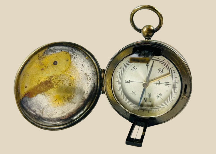 Antique French brass pocket compass with hinged lid, glass-covered dial, and sighting lens, marked “Made in France,” circa 1900–1930.