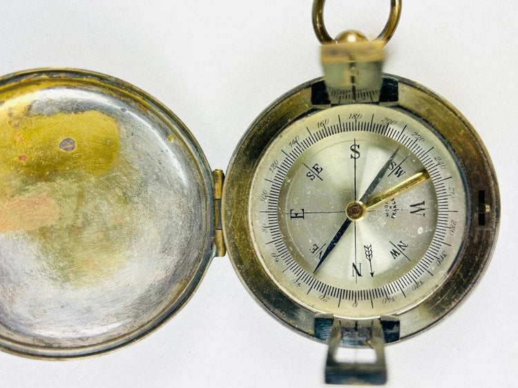 Antique French brass pocket compass with hinged lid, glass-covered dial, and sighting lens, marked “Made in France,” circa 1900–1930.