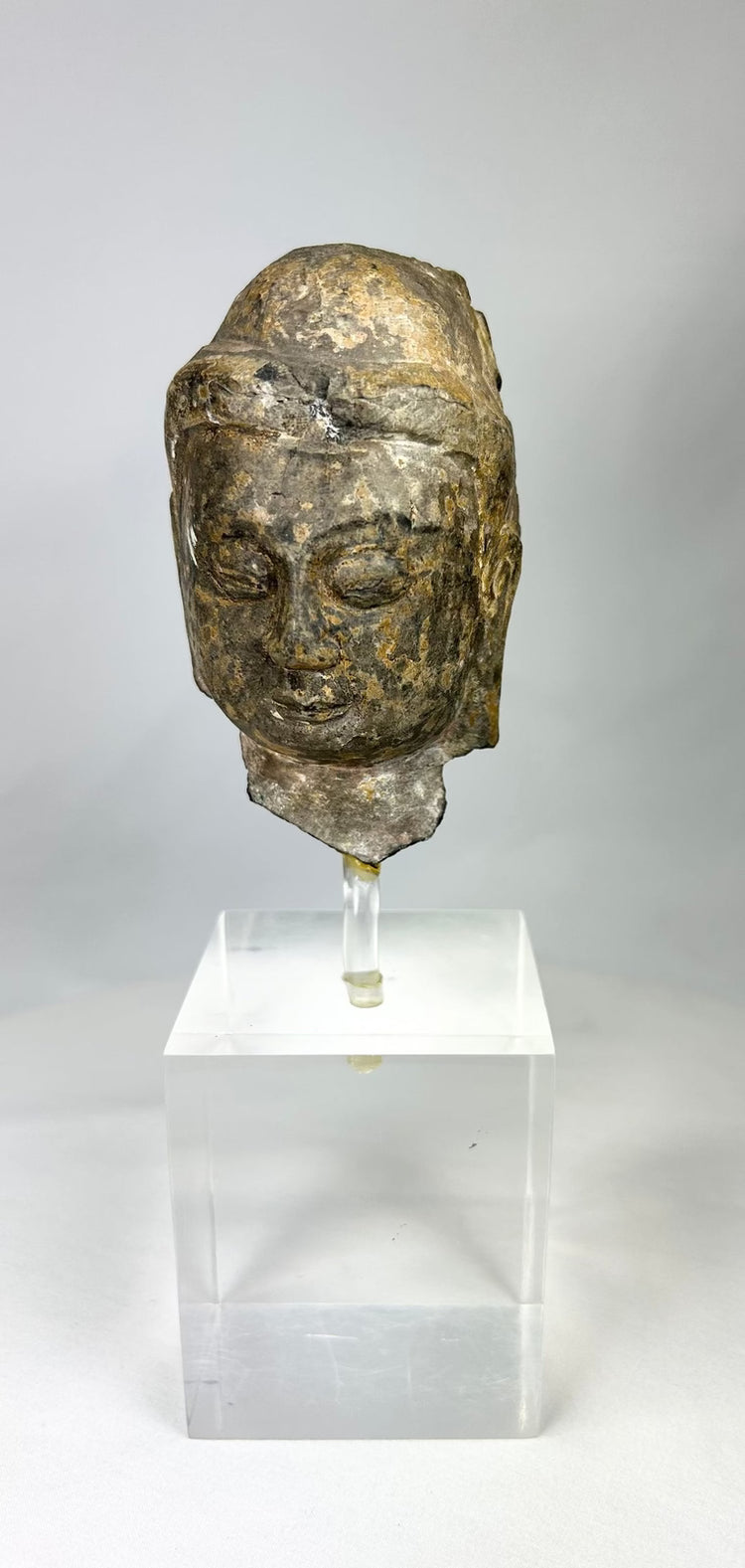 Ancient Gandhara Buddhist sculpture fragment depicting Buddha head, Greco-Roman style, carved stone