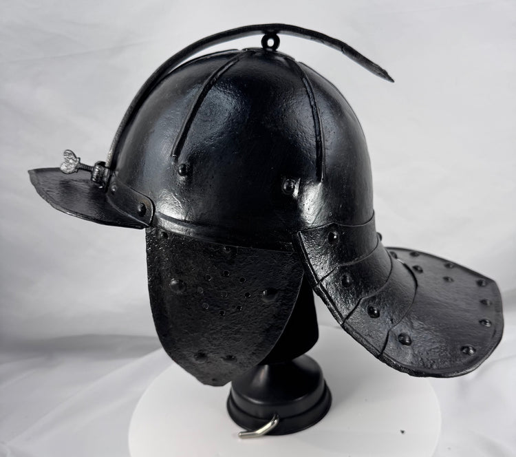 Antique European military helmet from the Thirty Years' War era with articulated neck guard and forged iron construction.