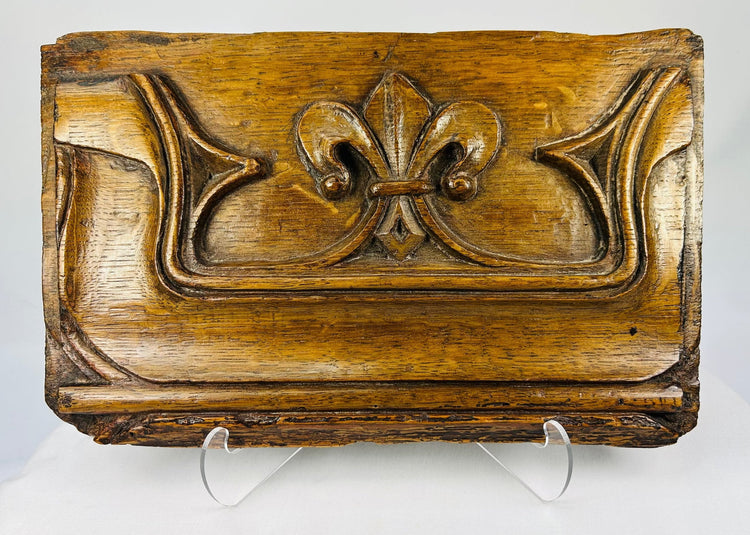 16th-century carved oak Gothic panel with fleur-de-lis motif on a white background