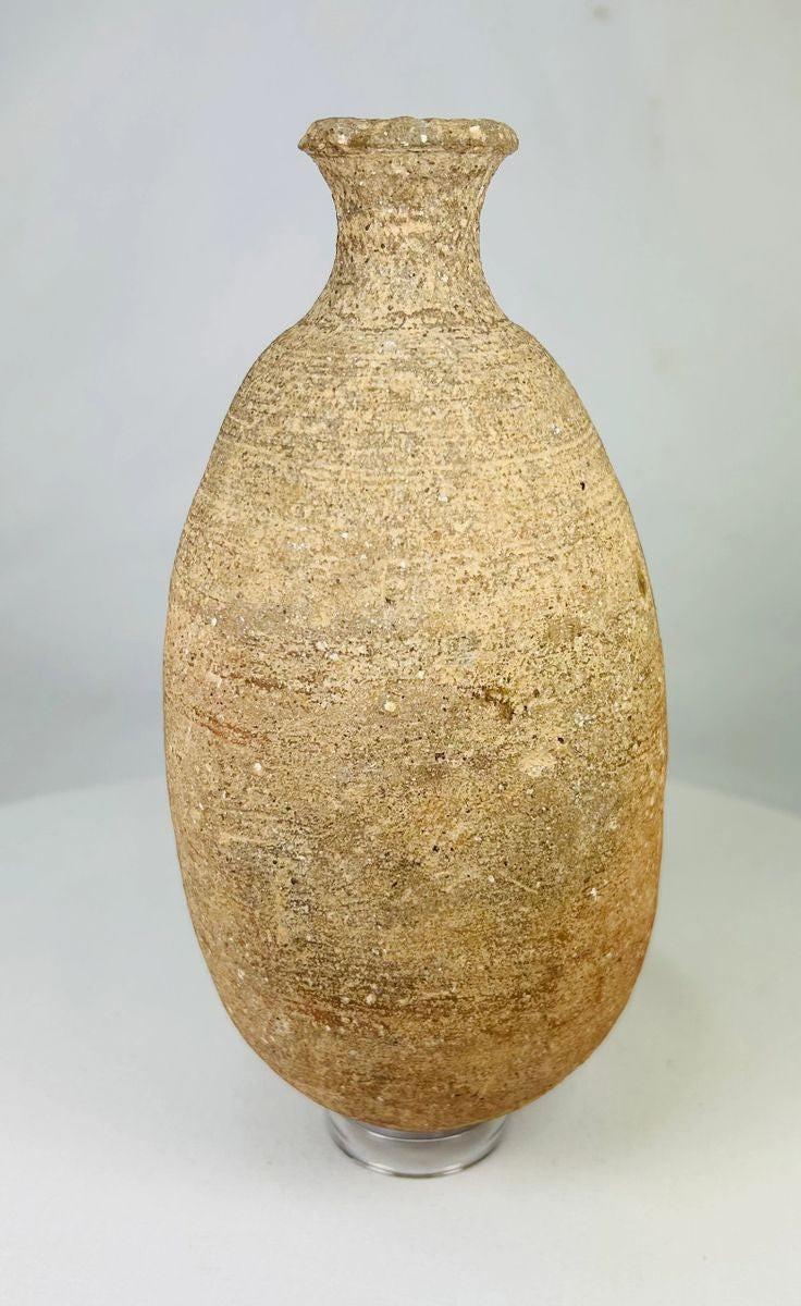 Ancient Greco-Roman terracotta storage amphora, circa 1st–3rd century CE, tall vessel with narrow neck and aged earthen patina.