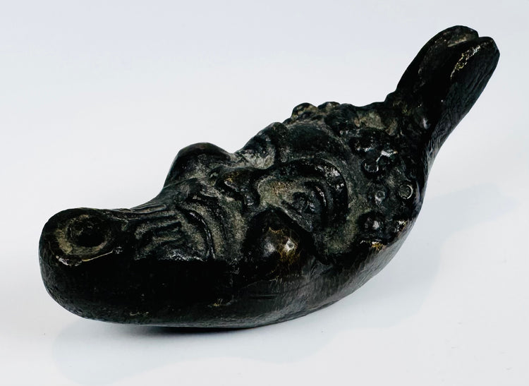 Grotesque satyr head oil lamp from Europe with aged surface patina and compact display size.