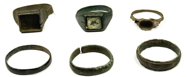 Collection of six Roman and Early Byzantine bronze rings arranged together showing varied archaeological jewelry styles