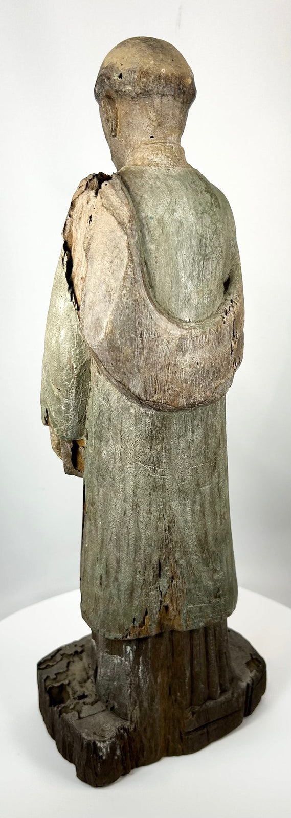 Antique santo figure with extended arm and scripture book detail