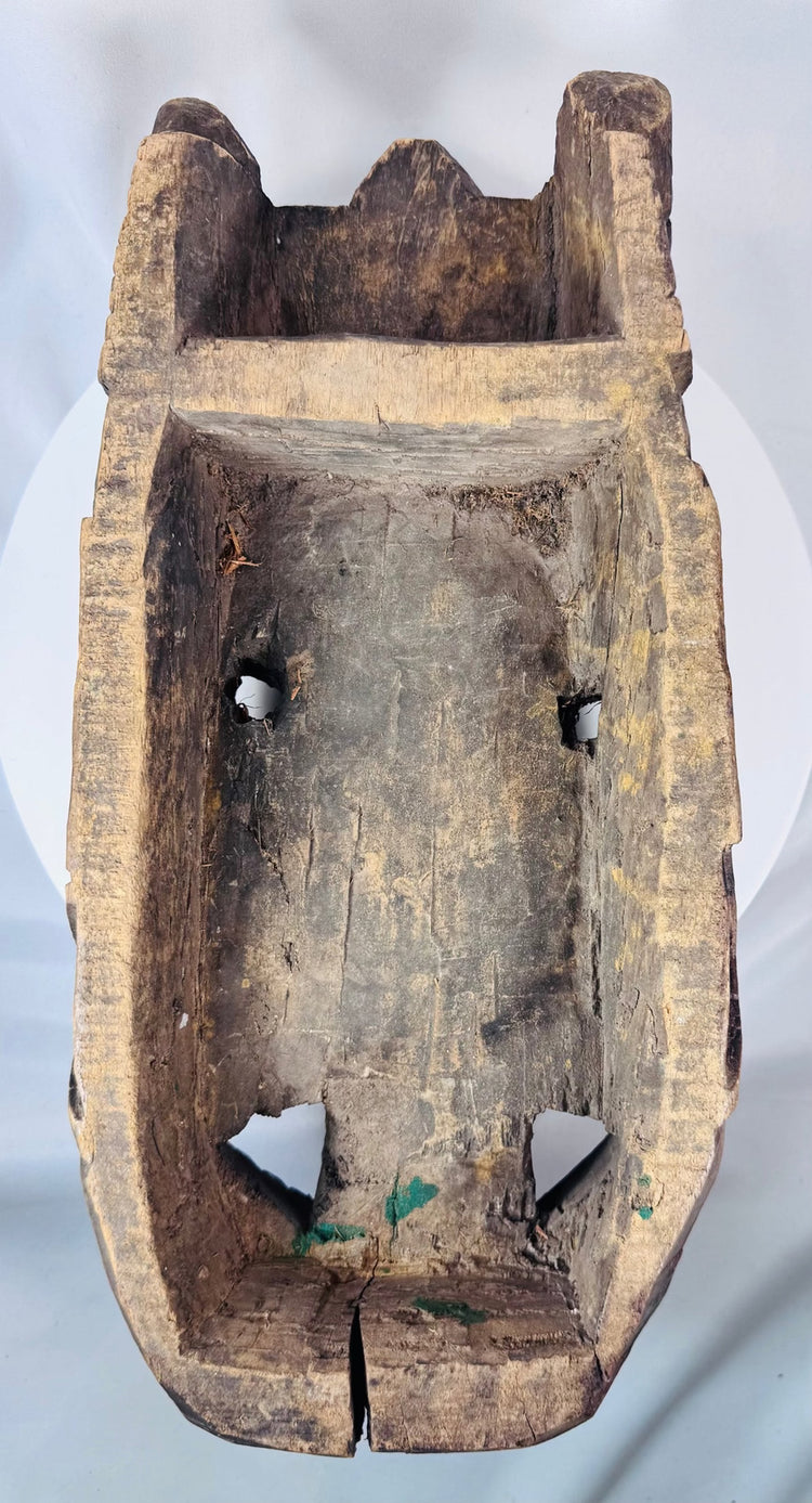 Traditional tribal mask with carved teeth, prominent nose, and dark aged hardwood construction.