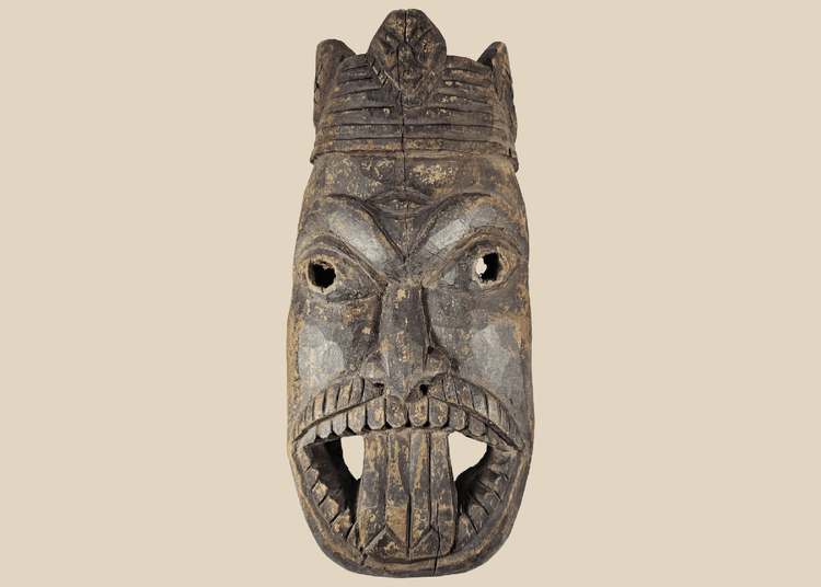 Antique West African ceremonial mask with carved third eye, open mouth, and expressive tribal features.