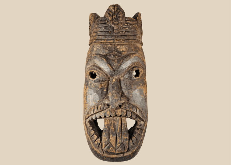 Antique West African ceremonial mask with carved third eye, open mouth, and expressive tribal features.