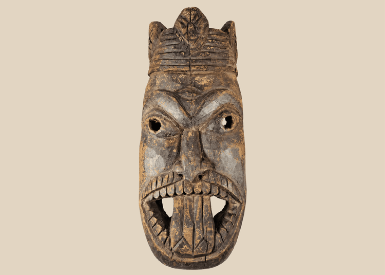 Antique West African ceremonial mask with carved third eye, open mouth, and expressive tribal features.